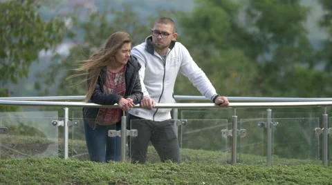 View of a couple talking and leaning on the railing in Alba Iulia Stock Footage 57529887