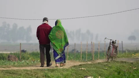 View of a couple walking through rural fields in Bogura, Bangladesh. 스톡 동영상 334972088