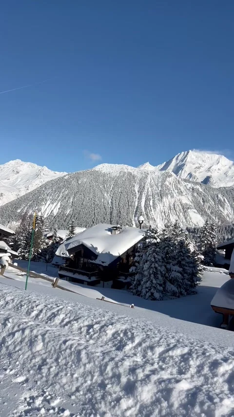 View of Courchevel ski resort chalets by the slopes under snow by winter Stock Footage 334414375