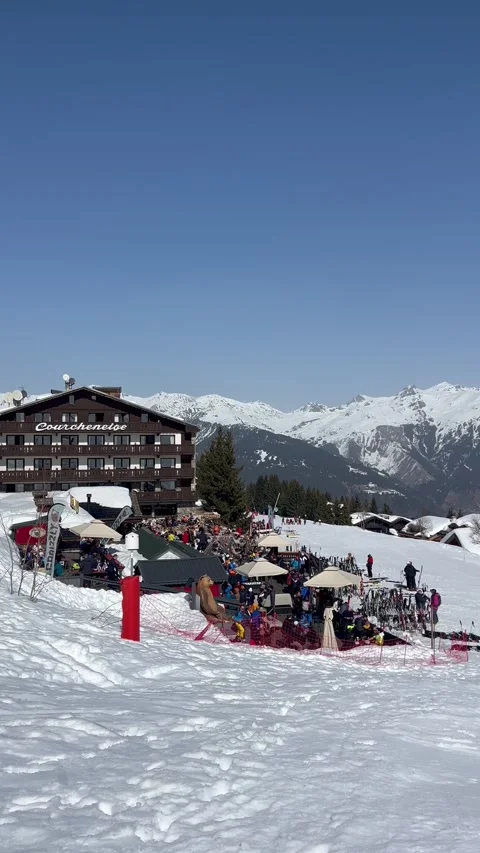 View of Courchevel ski resort slopes with chalet in the background Stock Footage 334430663
