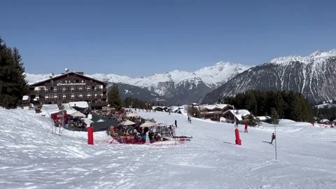 View of Courchevel ski resort slopes with chalet in the background. Stock Footage 334430740