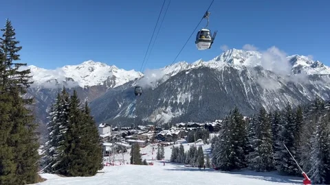 View of Courchevel ski resort slopes and town in the background by winter Stock Footage 337092401