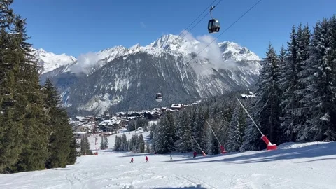 View of Courchevel ski resort slopes and town in the background by winter Stock Footage 337093220