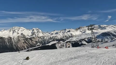 View  of Courchevel winter resort with ski lifts over slopes Video stock 336971695