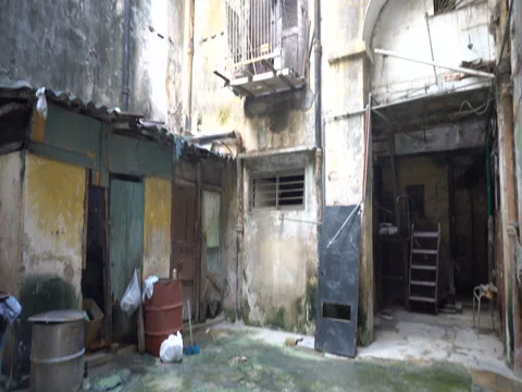 View up to a courtyard of old dilapidated poor houses in the slums at Hav Stock Footage 71038238