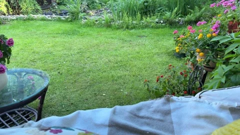View from a Cozy Garden Swing Over Summer Backyard and Blooming Flowers Video stock 336606223