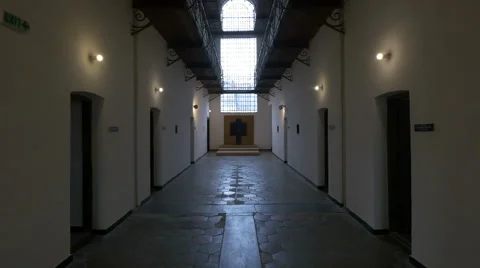 View of a cross at the end of the prison's hallway at Sighet Memorial Museum Stock Footage 60116031