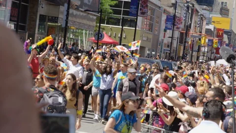 View from the crowd of a packed Toronto pride parade - slow motion - shot on RED Stock Footage 124344284