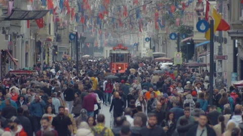 View of a crowd of people and a red tram on Istiklal Street in Istanbul in Stock-Footage 255655528