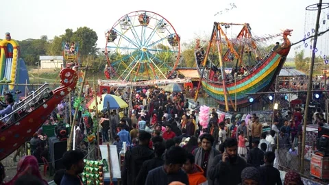 View of a crowded amusement park with a Ferris wheel, Bangladesh. Video stock 335015524