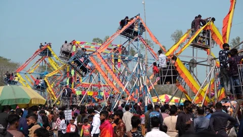 View of crowded fairground with manual Ferris wheels, Bangladesh. Video stock 335013951