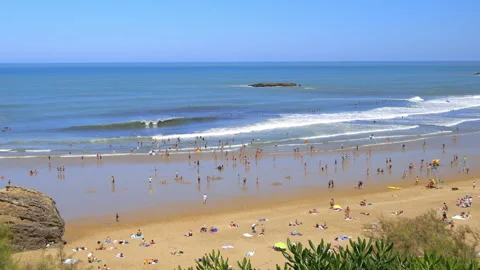 View of crowds of beachgoers sunbathing and swimming in Biarritz France Stock Footage 340606484