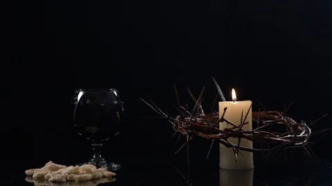 View of Crown Of Jesus, Candle Bread and Wine on Black Background Stock Footage 130142656