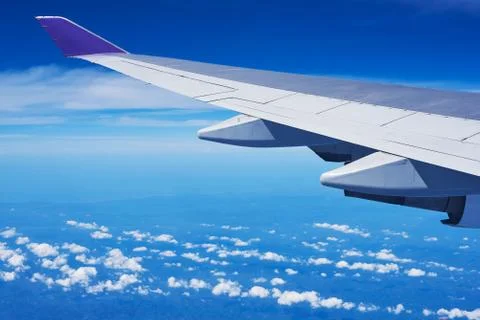 View of cumulus clouds and blue sky from airplane Stock Photos