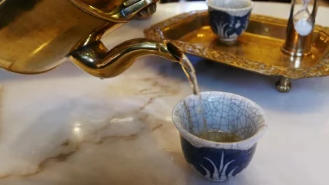 View to a cup of tea while pouring tea from tea pot in chinese japanese mod.. Stock Footage 279443852