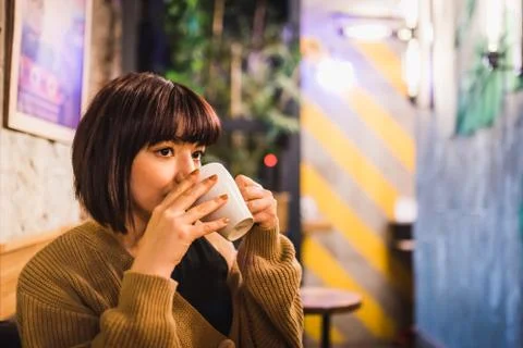 View of Cute young girl while sitting in a cafe Stock Photos