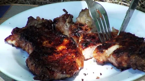 View of cutting a piece of roasted meat on the plate. Stock Footage 67829963