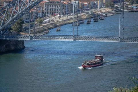 View of D. Luis bridge, Douro river with boats and Gaia city as background Stock Photos
