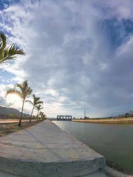View of the dam with palm trees and blue sky in the background Fotos Stock