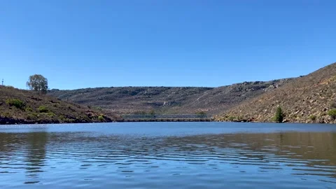 View of dam wall from speed boat on Bulshoek Dam, South Africa Stock Footage 181468518