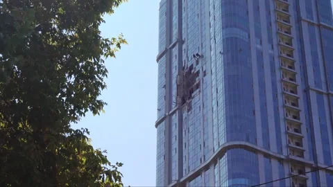 View of damaged apartment complex with broken windows, attack drone Stock Footage 282733320