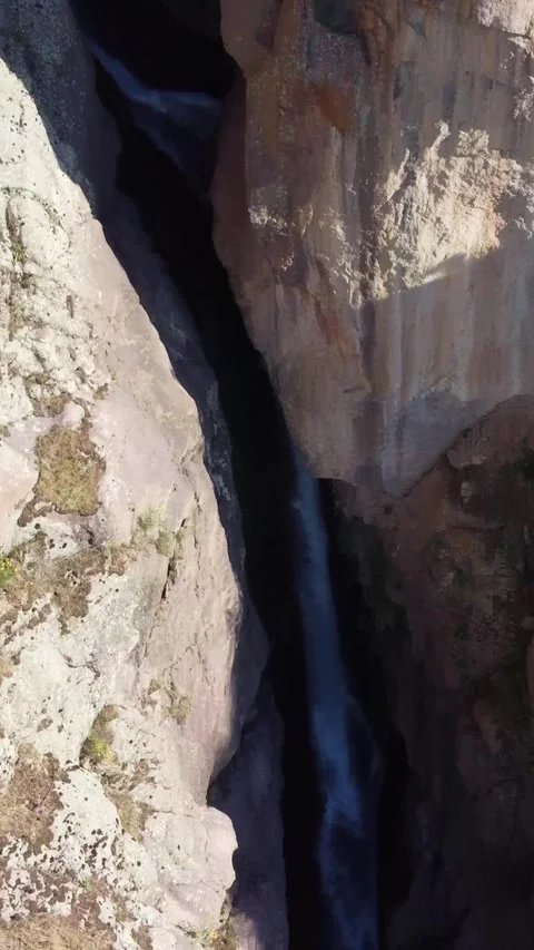 View of dark Akkum waterfall chasm and massive rock walls in Kazakhstan Stock Footage 338123323