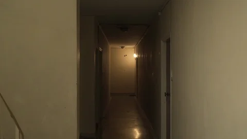 View of a dark corridor inside an old type apartment block building Stock Footage