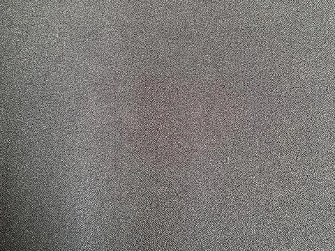 View of a dark grey textured fabric background with a fine woven pattern Stock Photos