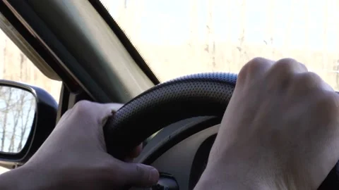 View on the dashboard of the car driving.The driver is holding the steering Stock Footage 108062099