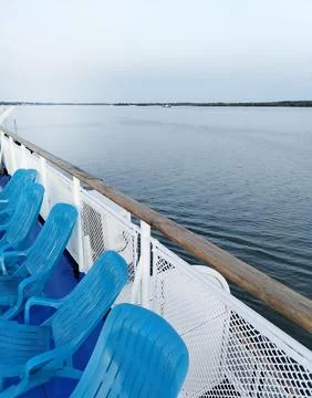 View from the deck of a cruise ship to a row of deck chairs near the side, .. Stock Photos