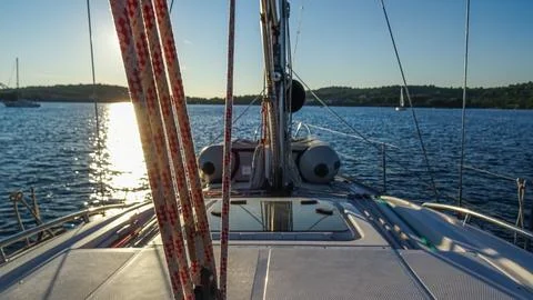 View from the deck of a sailing boat during sunset Stock Photos