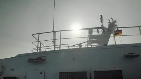 A view from the deck of a ship with a German flag fluttering in the wind Stock-Footage 286078033