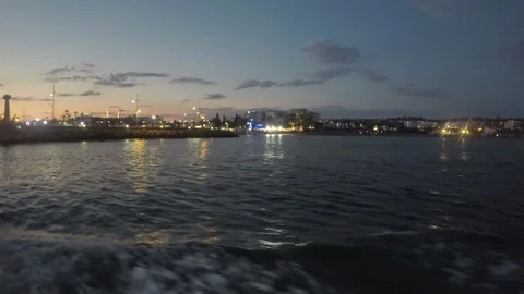 View from the deck of the ship to the night port into which the ship enters Stock Footage 95700918