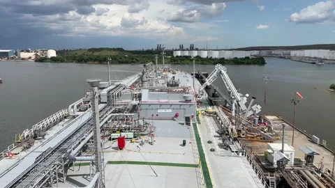 View from the deck of the ship to the shore and gas tanks. Stock Footage 238563168