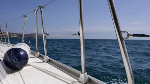 View from the deck of the yacht on the bow, close-up. Side view with green sea Stock Footage 231182383