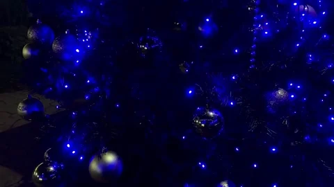 View of the decorated Christmas tree with a garland and New Year's balls. 4k Stock Footage 340764614