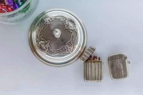 View of a decorative antique metallic objects, metal cup and metal matchbox Stock Photos