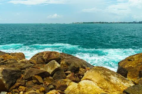 View of the deep blue ocean from the rocky shore Stock Photos