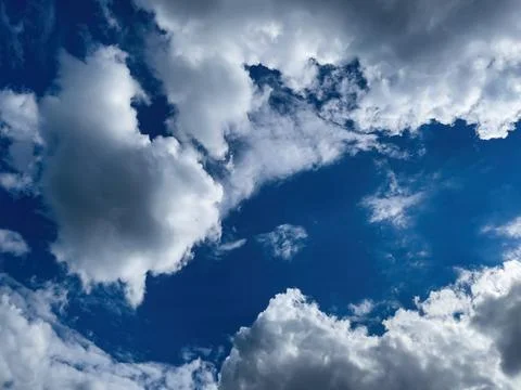 View on deep blue sky. Cloudscape photography on a daytime. Stock Photos