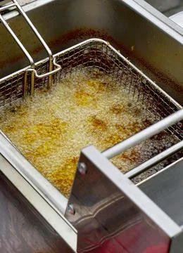 View of deep frying of spring or tornado potato chips,in oil 스톡 사진