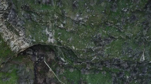 View of deep rocky abyss and hiking path on green canyon wall in Kazakhstan Видео 337424117