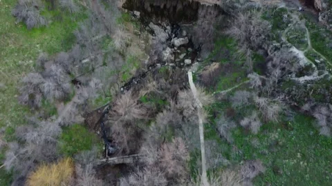 View of deep stone grotto with mountain creek and walking paths in Kazakhstan Vídeos de archivo 337467373