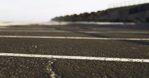 View of a deserted asphalt path along the coast during early morning hours Stock Illustration