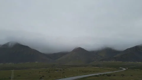 A view of the deserted fields and mountains in Iceland under the heavy clouds. Stock Footage 293086233