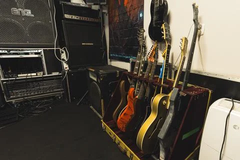 View of different color guitars, amplifiers and loudspeakers in the music studio Stock Photos