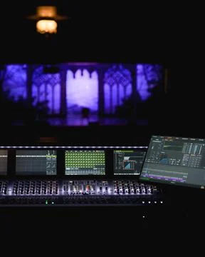 View of digital sound mixing console with illuminated screens at concert Stock Photos