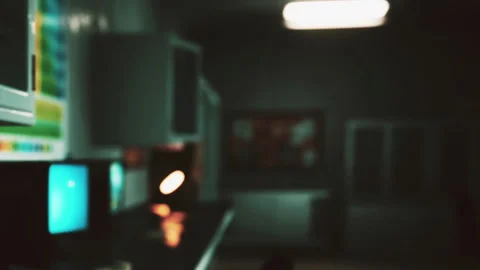 View of a dimly lit room with computers and a desk lamp during the evening Stock Footage 344965052