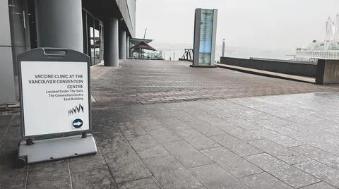 View of directional sign which points to the Vaccine Clinic Stock Photos