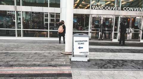 View of directional sign which points to the Vaccine Clinic Stock Photos