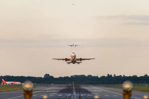 View directly down the runway as an easyJet Airlines plane takes off Stock Photos